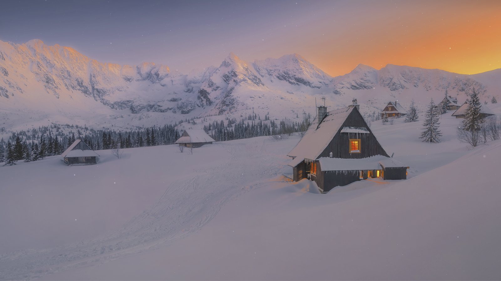 The Snowy Plains scene wallpaper running on a Mac desktop: a snow-covered cabin at sunset with falling snow.